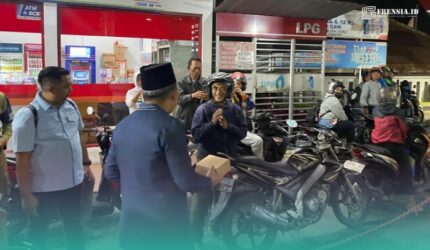 Bupati Jember, Muhammad Fawait saat membagikan makanan pada warga yang sedang antre mengisi bahan bakar minyak (BBM) di salah satu SPBU. (Foto: Dinas Kominfo Jember).