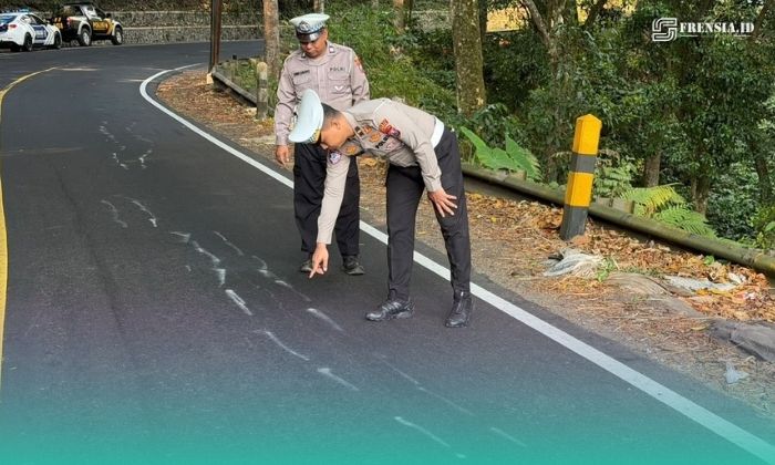 Petugas Satlantas Polres Jember saat mengecek kondisi jalan  raya jalur Jember-Banyuwangi yang retak. (Foto: Istimewa). 