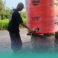 Ketua RT 001/RW 006, Dusun Kasengan, Desa Gumuksari, Kecamatan Kalisat, Suhermanto, saat mengecek kondisi tandon, setelah diisi ulang air bersih oleh BPBD Jember. (Foto: Fadli/Ketik.com).